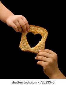 Sharing Food With The Needy - Kids Hands With A Slice Of Bread