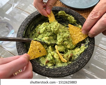 Sharing A Guacamole Dip With Tortilla Chips