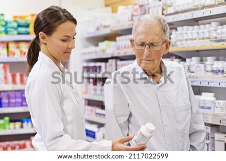 Sharing her wealth of knowledge. Shot of a young pharmacist helping an elderly customer.