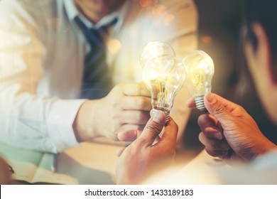 Sharing idea for help concept, Colleagues sharing a light bulb of idea - Shutterstock ID 1433189183
