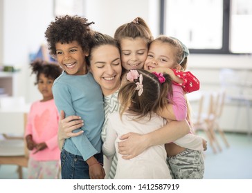 Sharing love. Children with teacher in preschool.