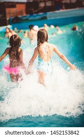 Sharing waves, and summer fun. Children in pool. - Shutterstock ID 1452153842