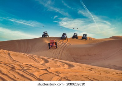 Sharjah Desert Dubai, United Arab Emirates - February 2015:  Tourists Driving Dune Buggy In Desert Near Dubai, UAE