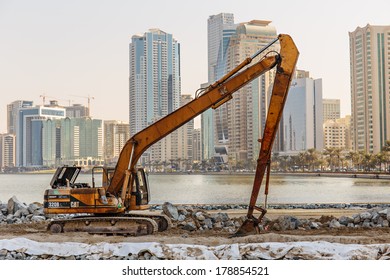 SHARJAH, UAE - OCTOBER 28, 2013: Excavator on a construction site. Sharjah is located along northern coast of Persian Gulf on Arabian Peninsula