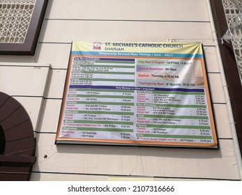 Sharjah, United Arab Emirates - January 16, 2022: Service Timings Notice Board At St. Michael's Catholic Church In Sharjah City. 