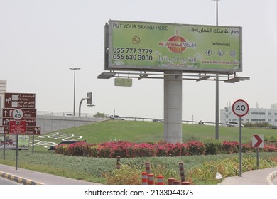 Sharjah, United Arab Emirates - March 7, 2022: Large Outdoor Advertising Display (unipole Billboard) Located On A Major Highway In Sharjah City. Out Of Home Advertising Concept.