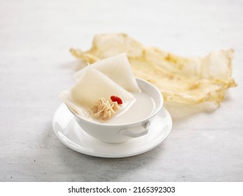 Shark Cartilage Soup With Fish Maw And Conpoy Served In A Bowl Isolated On Wooden Board Side View On Grey Background