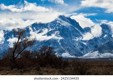 Shark fin trail in Lone Pine California. Snowy mountains with rolling clouds after a winter storm