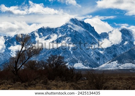 Shark fin trail in Lone Pine California. Snowy mountains with rolling clouds after a winter storm