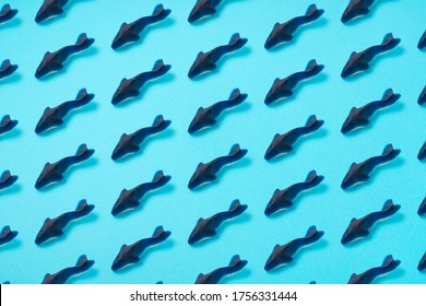 Shark Gummies Arranged Regularly On A Blue Background. Image For Background