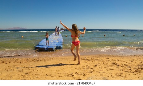 Sharm El Sheikh, South Sinai Egypt - 02.10.2022: Pontoon pier on the reef. Children on the pontoon pier on the beach.