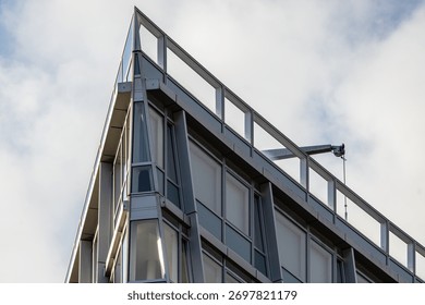 Sharp Angular Corner of a Modern Building Against a Cloudy Sky