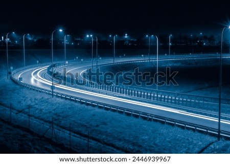 sharp bend of the road, long exposure of car lights at night