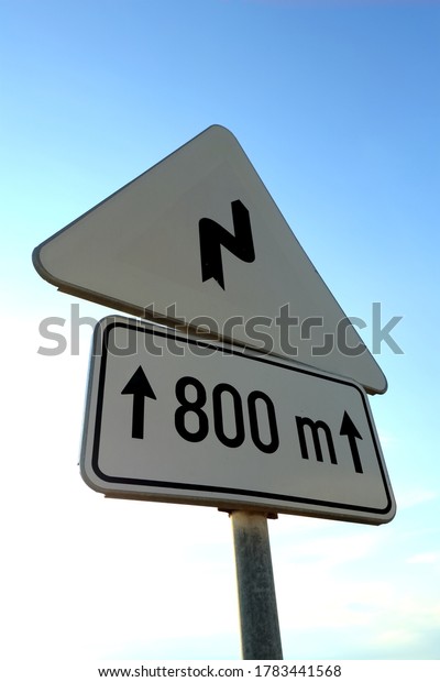 Sharp bend white\
traffic sign 800m ahead