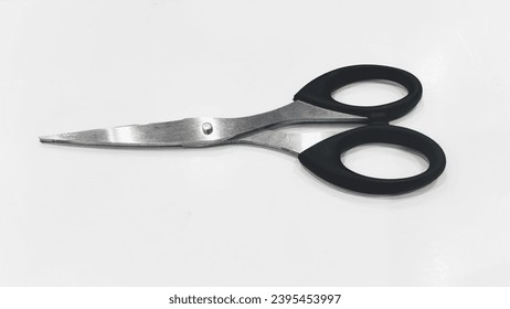 A sharp black scissors made from stainless steel - Shutterstock ID 2395453997