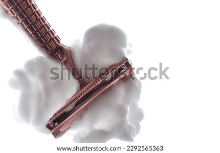 sharp blade razor with white shaving foam