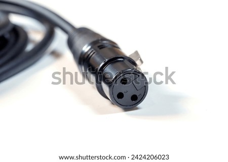 Sharp close-up shot of a three-pin XLR audio cable connector commonly used in professional audio equipment, isolated on a white background, cable end up close shot, nobody, shallow DOF