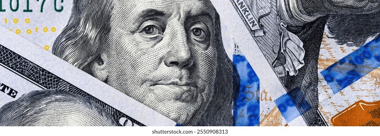 sharp, close-up view of benjamin franklins face from the one hundred dollar note.