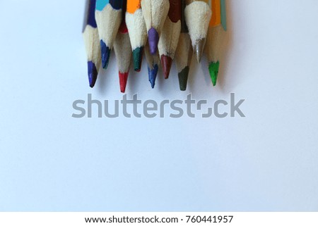 sharp colored pencils on a light background with copy space