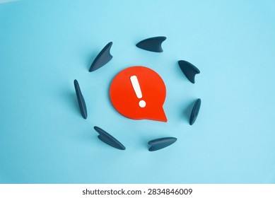 Sharp comment surrounded by shark fins. Harsh criticism and risk of backlash. Unpopular opinions can trigger attacks, controversy and public pressure.