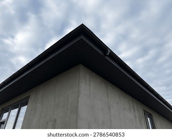the sharp corner of a modern building, likely under construction or renovation.
