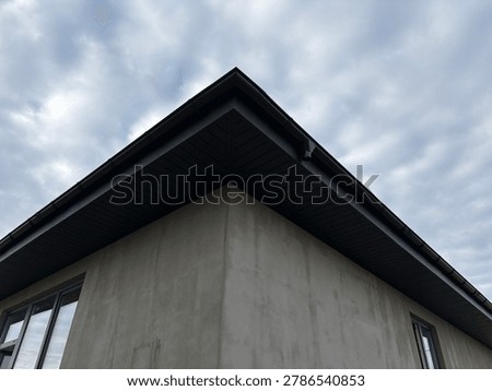 the sharp corner of a modern building, likely under construction or renovation.