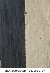 Sharp corner of a weathered concrete structure in sunlight.