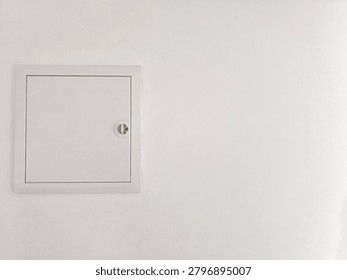 Sharp Focus Photography of Flush Mounted White Metal Utility Access Door on Seamless Clean White Wall