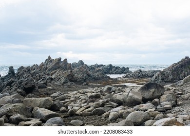 sharp jagged basalt rocks on the sea coast, Cape Stolbchaty on Kunashir Island - Shutterstock ID 2208083433