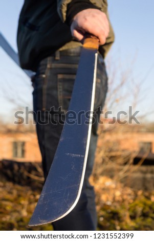 
Sharp machete blade close-up in hands