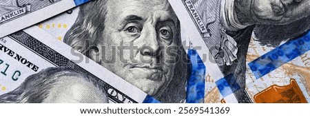 sharp macro shot of benjamin franklins face on the hundred-dollar note