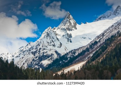 A sharp mountain peak.Sharp as a needle the mountain peak rises above the valley