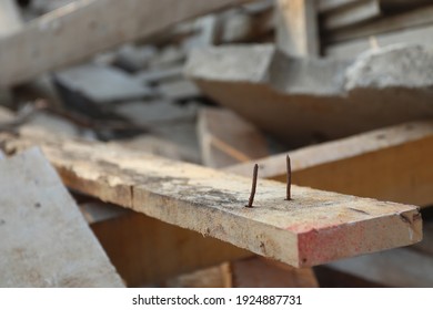 Sharp nails on piece of abandoned wood, selective focus. Dangerous in work. Harzardous or risk at construction site.