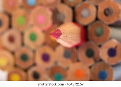 Sharp red pencil on background of colored pencils. Selective focus
