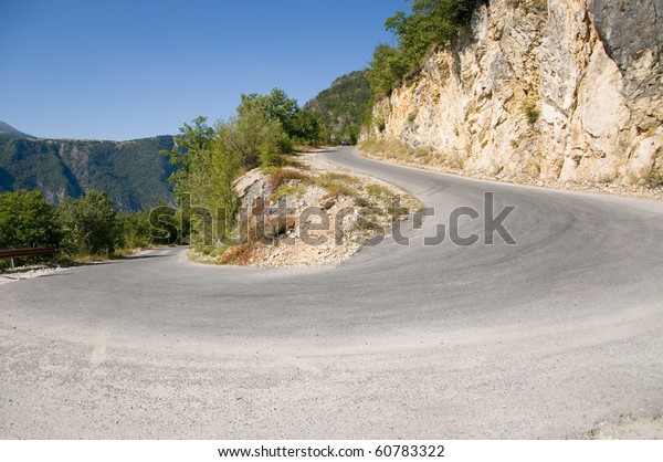 Sharp road curve in high\
mountains