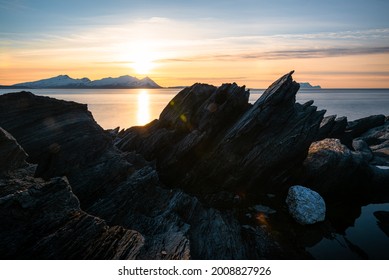 Sharp Rock Formation At A Fjord Landscape In Northern Norway On A Warm Summer Evening With Midnight Sun