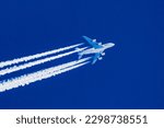 Sharp telephoto close-up of jet plane aircraft with contrails cruising from Dubai to San Francisco, altitude AGL 39,000 feet, ground speed 510 knots.
