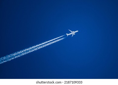 Sharp telephoto close-up of jet plane aircraft with contrails cruising from Tokyo to Boston, altitude AGL 37,000 feet, ground speed 548 knots. - Powered by Shutterstock