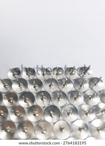 Sharp tip silver metal tack on white background.