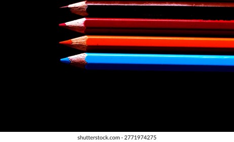 Sharp Tips of Red Blue and Orange Pencils Aligned