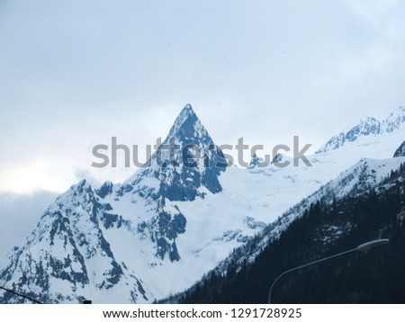 The sharp top of the snow-capped mountain