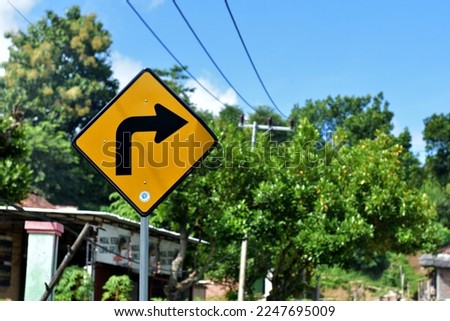 Sharp turn right. Beware! DINAS PERHUBUNGAN KAB. BOJONEGORO Means DEPARTMENT OF TRANSPORTATION. BOJONEGORO DISTRICT.