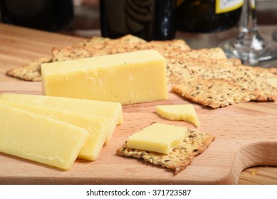 Sharp White Cheddar Cheese With Crackers And Wine, Shallow DOF Focus Near Front