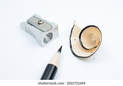 Sharpener and a broken pencil. Shavings and a graphite on white background. Close up, Macro photo. Back to school concept. - Powered by Shutterstock