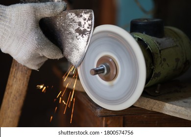 Sharpening an ax on a sharpener close-up