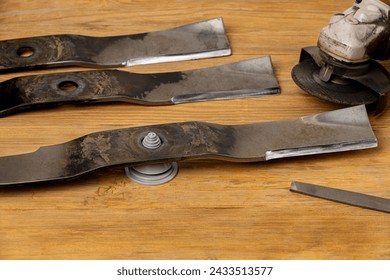 Sharpening and balancing dull lawnmower blades. Lawn mower equipment maintenance, repair and service concept.