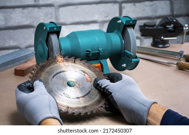 Sharpening Circular Saw, worker sharpens saw with a electric sharpener.