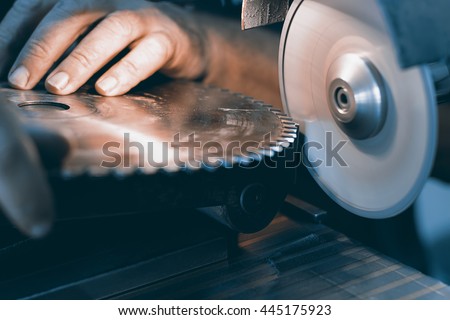 Sharpening  Circular Saw, worker sharpens a circular saw blade