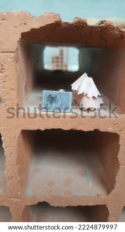 sharpner and led pensil placed somewhere on a cement block