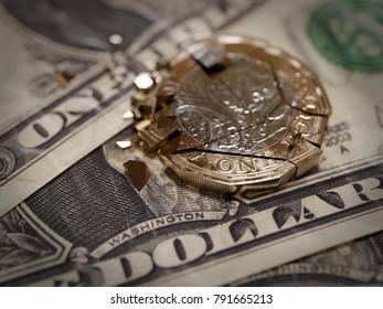 Shattered British Pound Coin On US One Dollar Bills